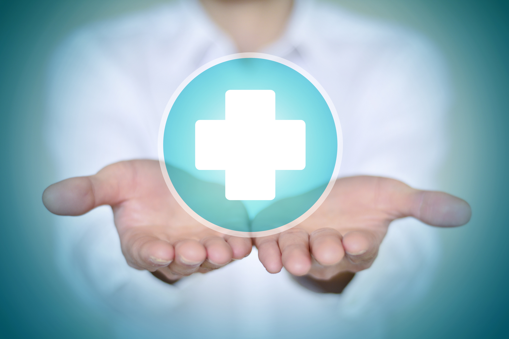 Close-up man in white shirt holding white first aid icon.